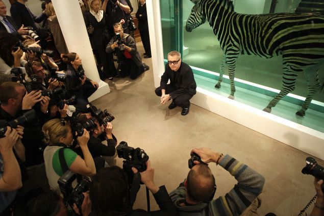 British artist Damien Hirst poses for photographs before his 2008 of more than 200 of his own works.